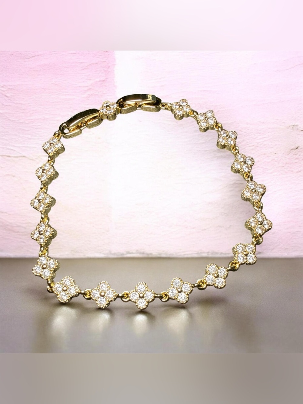 Gold-tone clover link bracelet featuring pavé-set cubic zirconia crystals